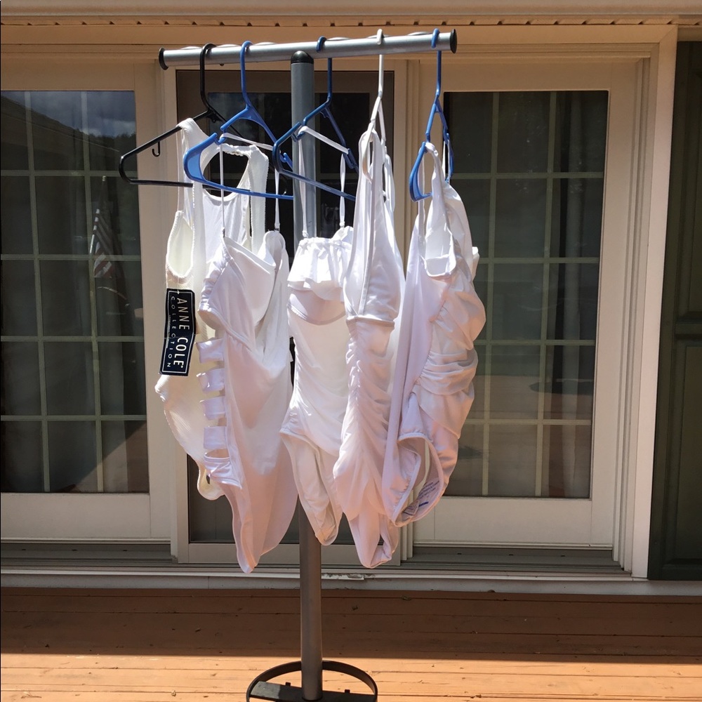 5 white one-piece bathing suits.
